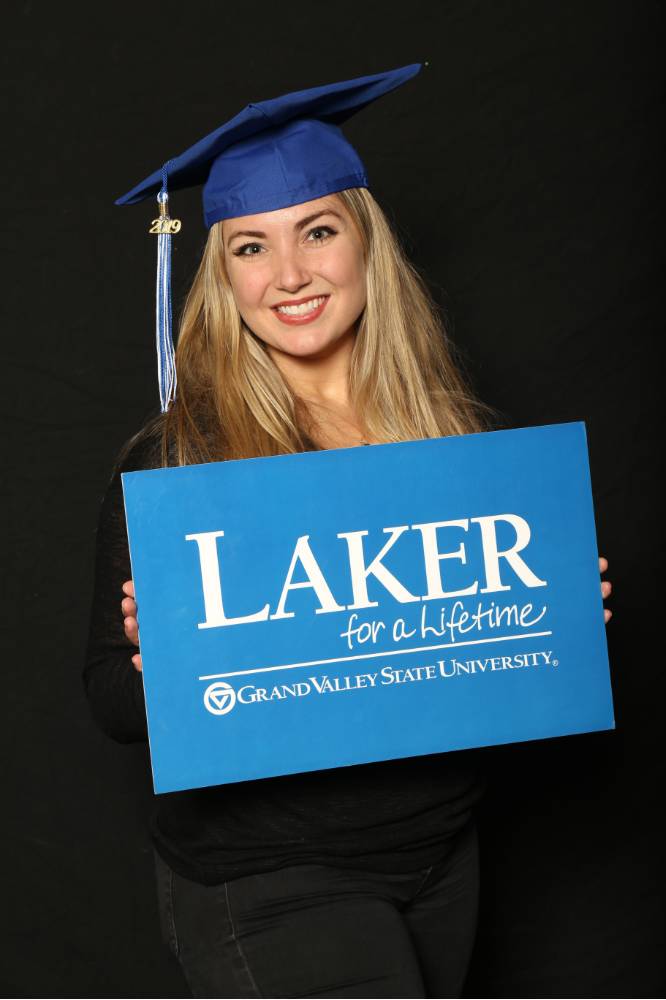 blonde student holding laker sign